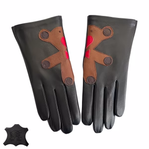 A pair of women's black Italian aniline leather gloves displayed on a white background. Each glove features a brown leather patch that, when joined, forms a cute teddy bear with red heart details.