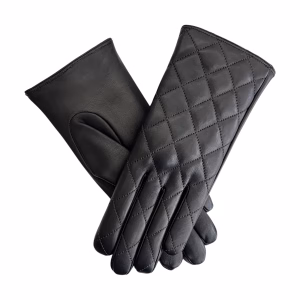 An elegant close-up of a pair of black quilted leather gloves crossed in an 'X' formation against a white background, highlighting the luxurious texture and uniform diamond pattern.