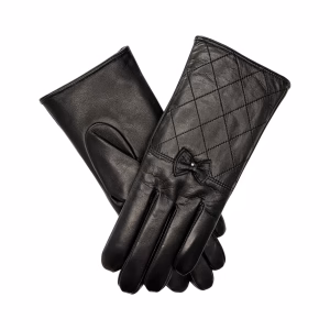 A pair of women's black Italian aniline leather gloves with a quilted diamond pattern on the back of the hand. The wrist is adorned with a delicate black leather bow and a small gold-toned metal accent.